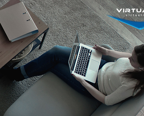 birds-eye view of woman sitting on couch holding a laptop